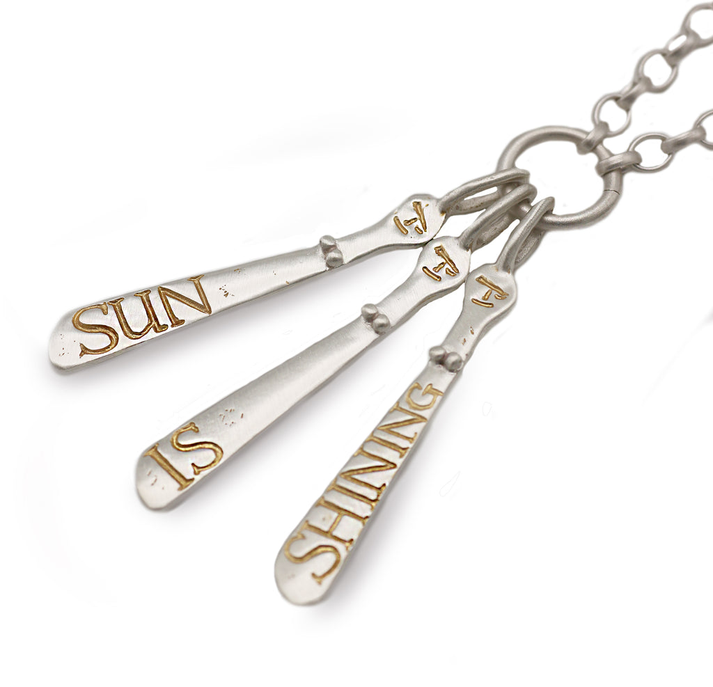 Bespoke silver Sibyls etched with personalised words in gold etching.