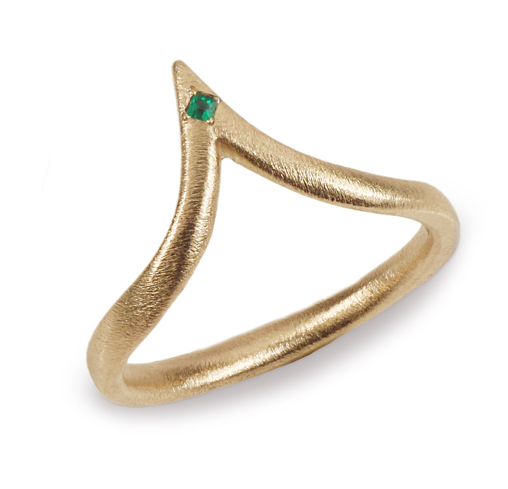 Gold extended wishbone ring with a green emerald on white background 