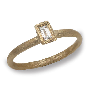 Yellow Gold Baguette Cut Solitaire Ring on a white background 