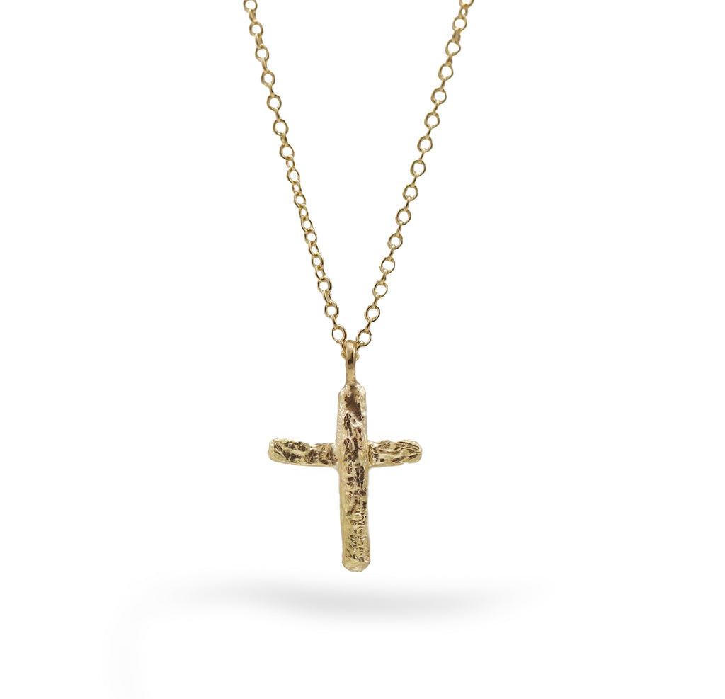 Yellow gold textured cross pendant on a fine gold chain. 